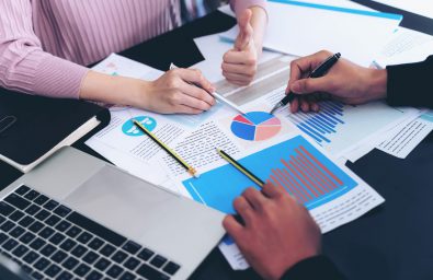 close up hand of  Business man busy at office desk  on  Notebook and documents  working  , business concept